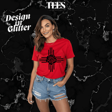 Load image into Gallery viewer, Woman wearing red New Mexico Zia glitter t-shirt with black rose design and ripped denim shorts