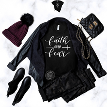Load image into Gallery viewer, faith over fear t shirt black with white text front view styled with jacket boots hat and purse
